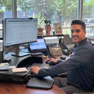 VSO agent smiling and sitting behind his desk