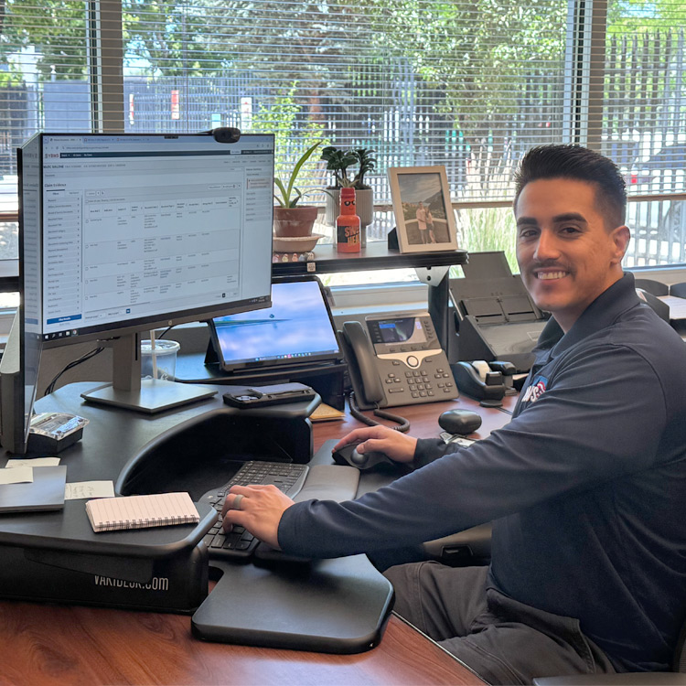 VSO agent smiling and sitting behind his desk